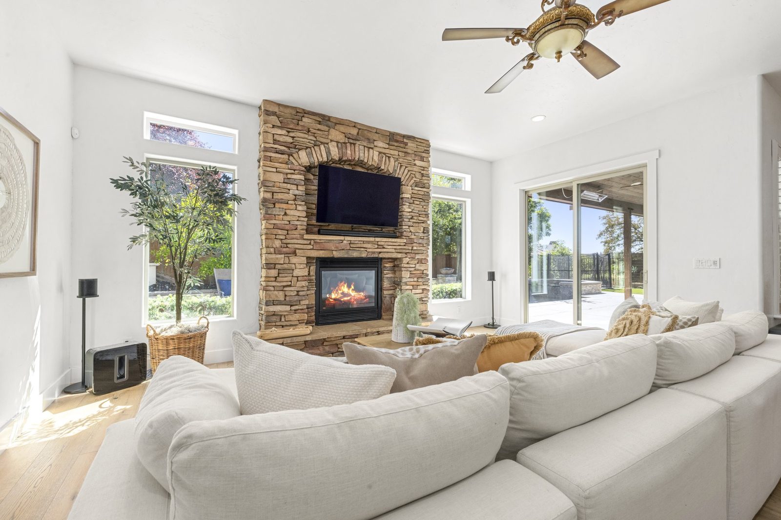 The great room, with the stone fireplace and the doors out to the pool