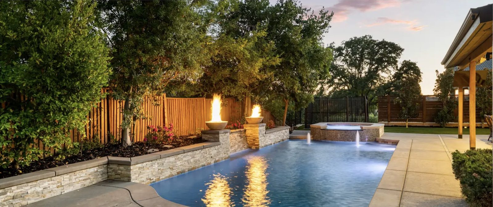 The pool, the spa and the fire bowls at dusk