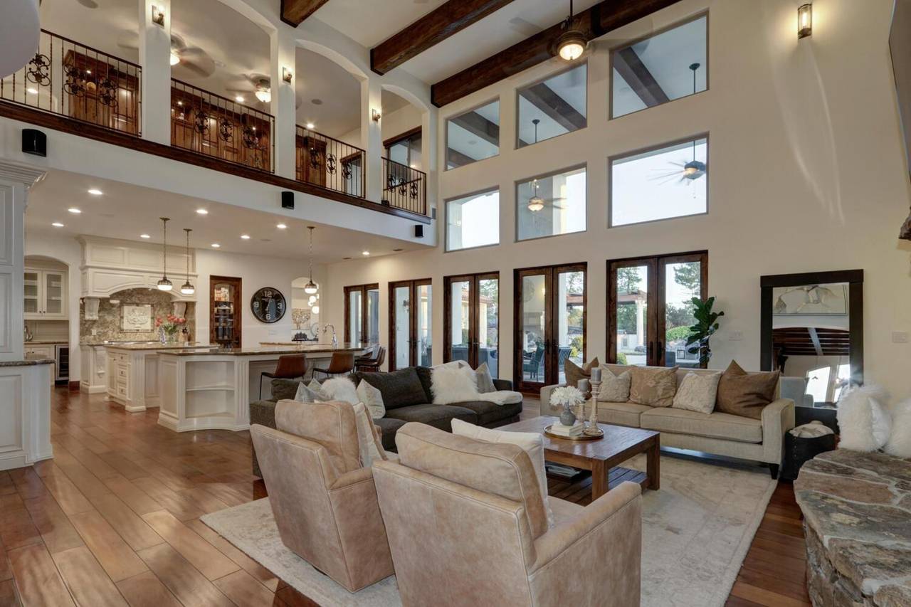 The living room under a two storey ceiling, open through to the kitchen