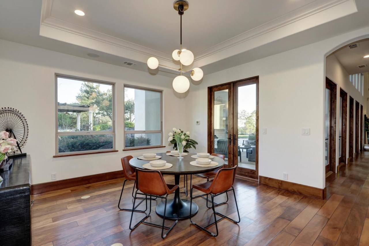 The dining area, with a round table under a globe pendant