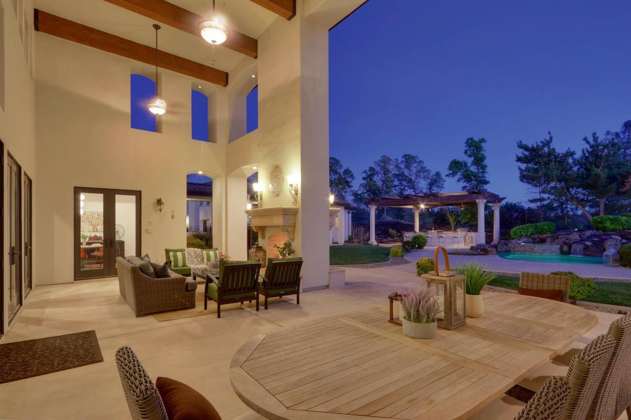 The back of the great room at dusk, opening onto the covered patio