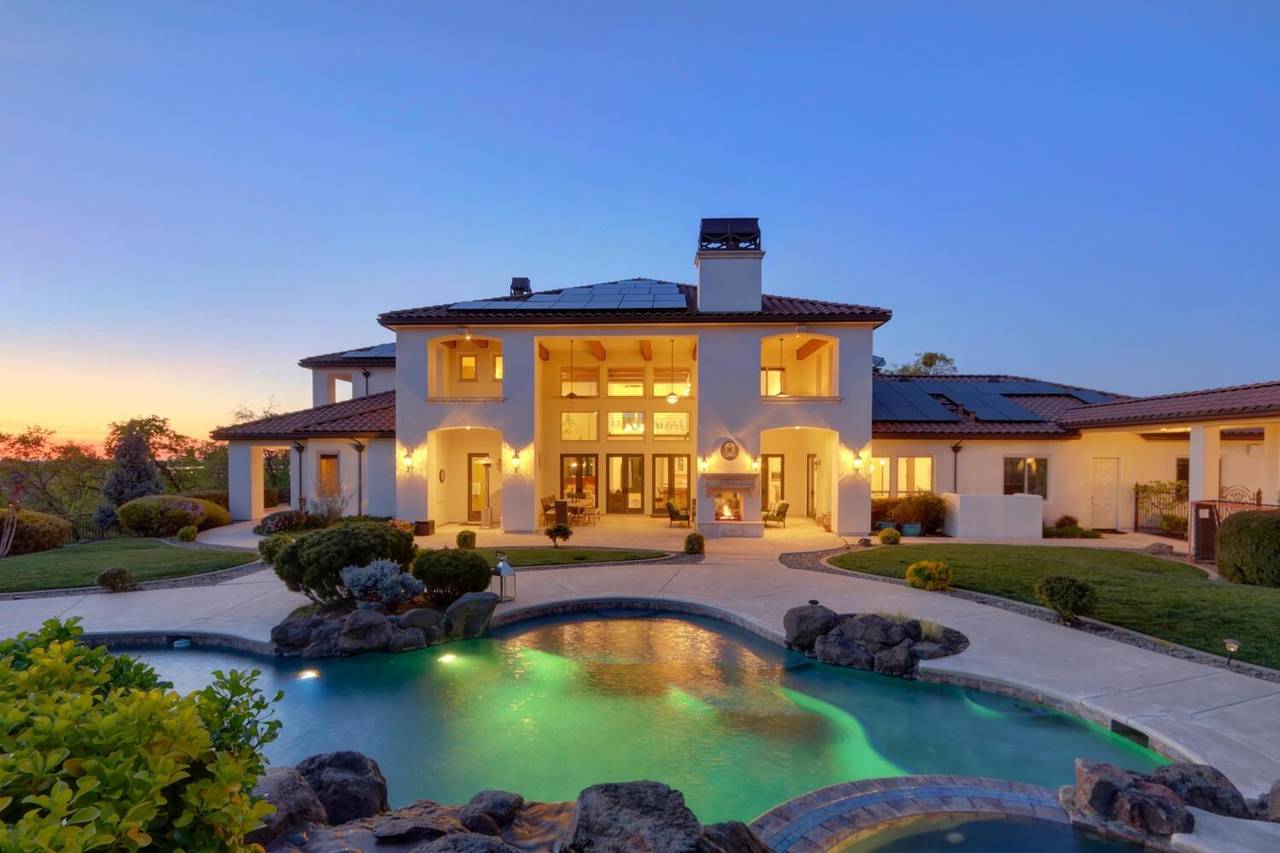 The back of the house at dusk, seen across the pool