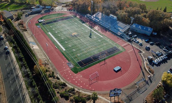 Aerial view of the Oak Ridge High School stadium and track in El Dorado Hills, with autumn trees around the campus